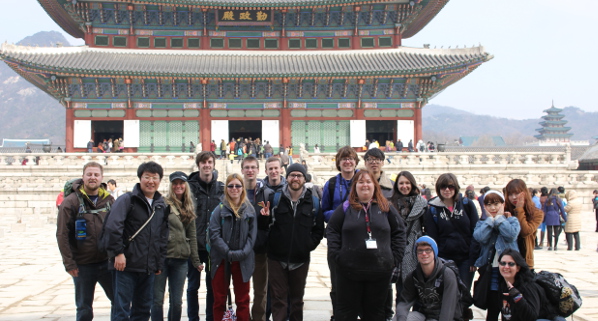 A group of students in front of a traditional Korean building