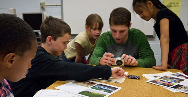 Art student teaching elementary students.