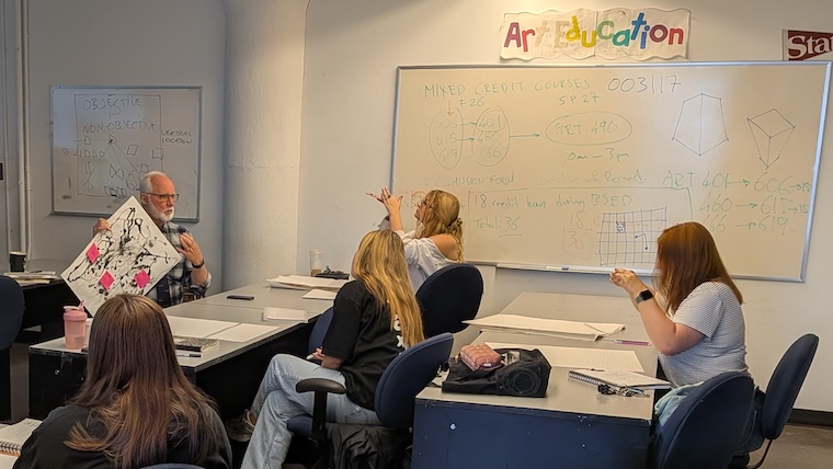 Instructor speaking to art students.
