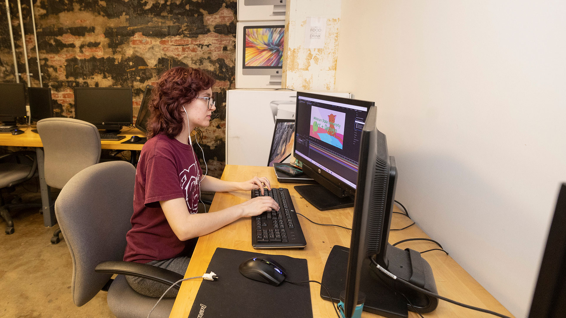 An art student, Gwen Layton, uses a computer for her art project.
