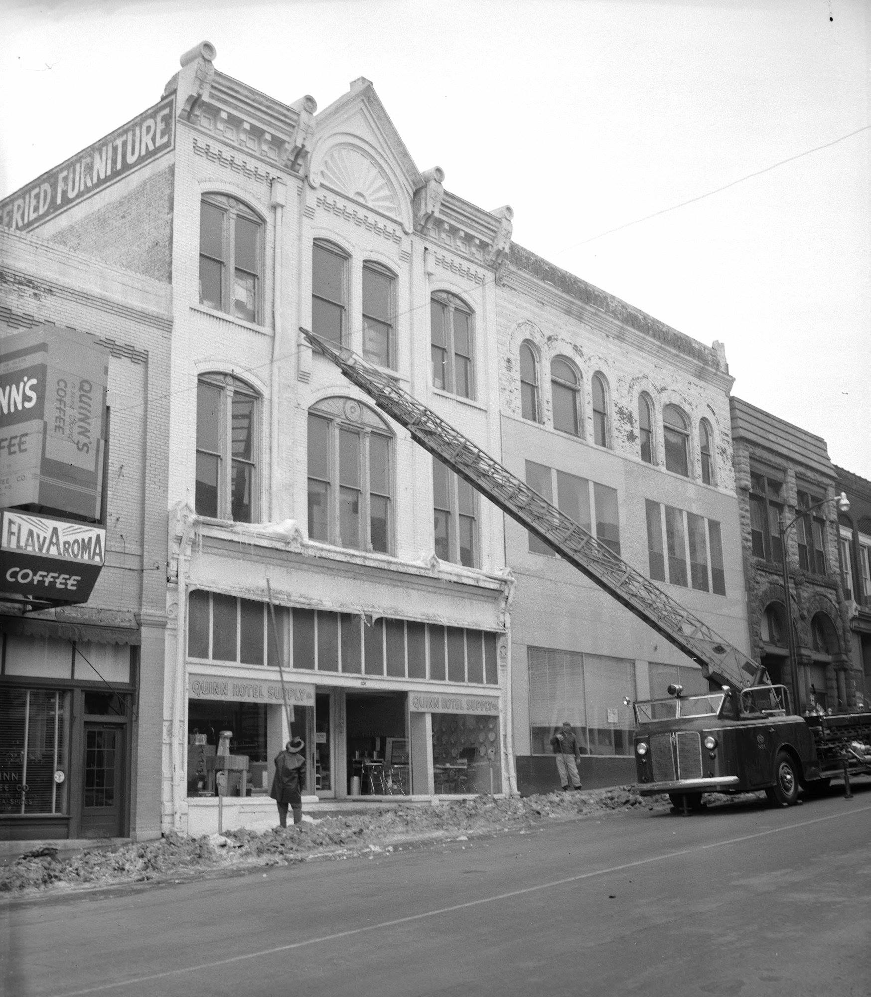 greyscale image of furniture shop with a firetruck