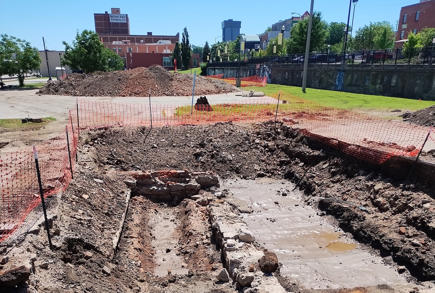 Excavated trenches in ex-parking lot on Mill