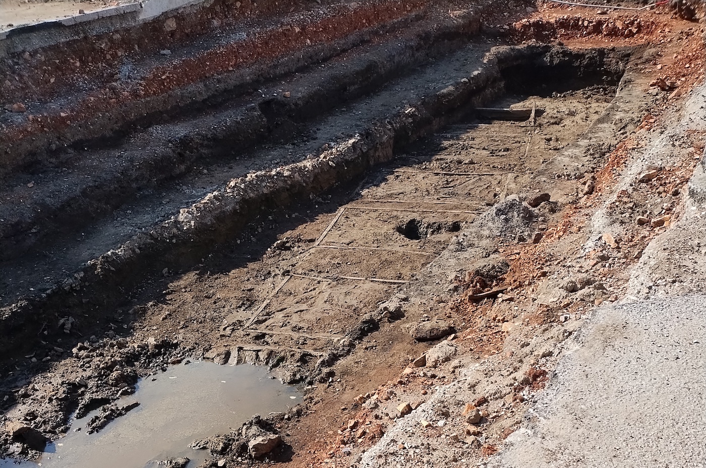 Trench with wooden framing visible at bottom