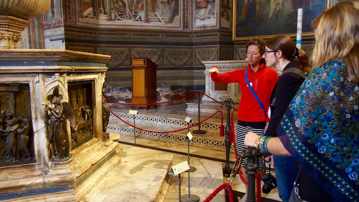 Professor Williams describing a relief sculpture to a student